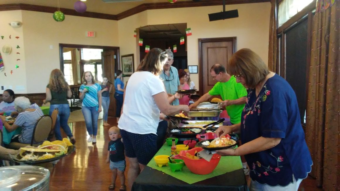 residents celebrating mexican heritage at a buffet