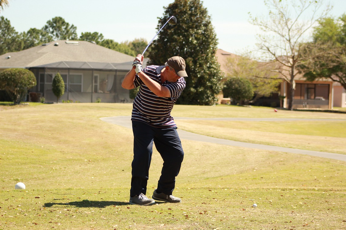 man playing golf at leland games