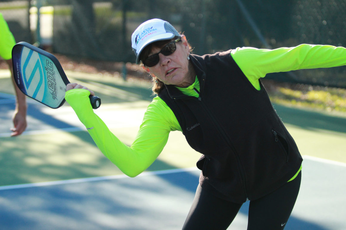 elderly woman playing pickleball at the leland games 2018