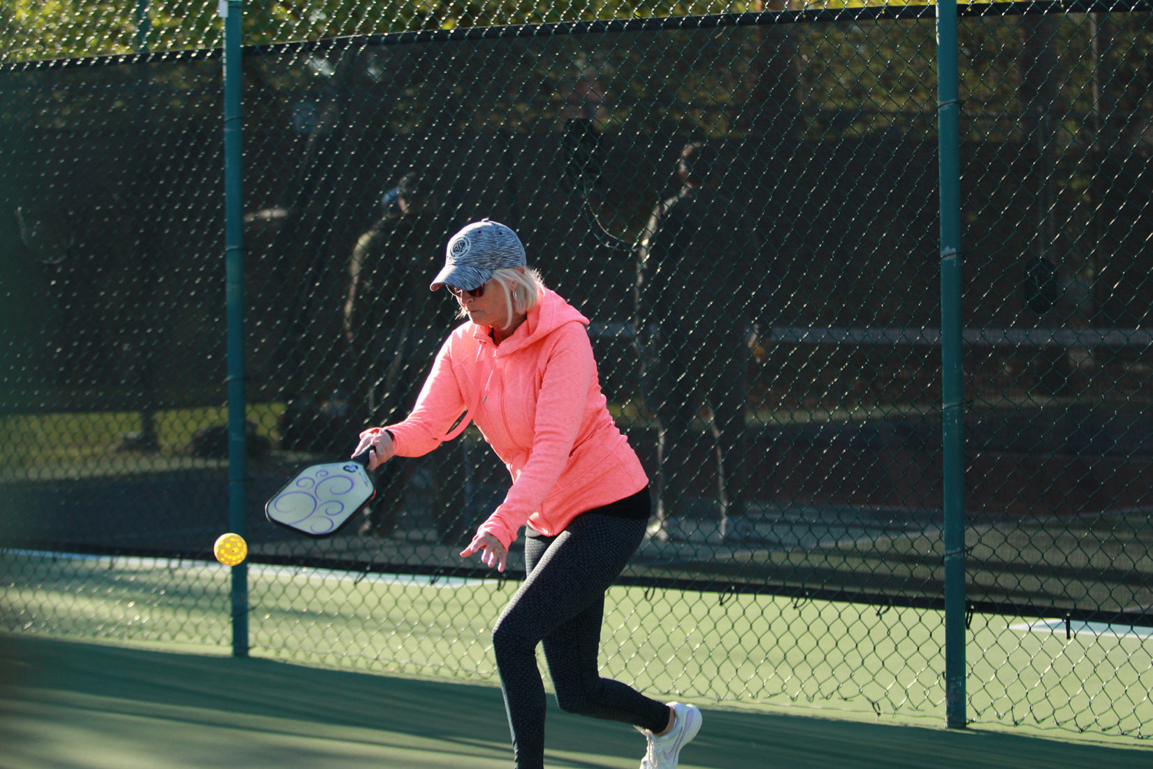 middle-aged woman playing pickleball at the leland games 2018